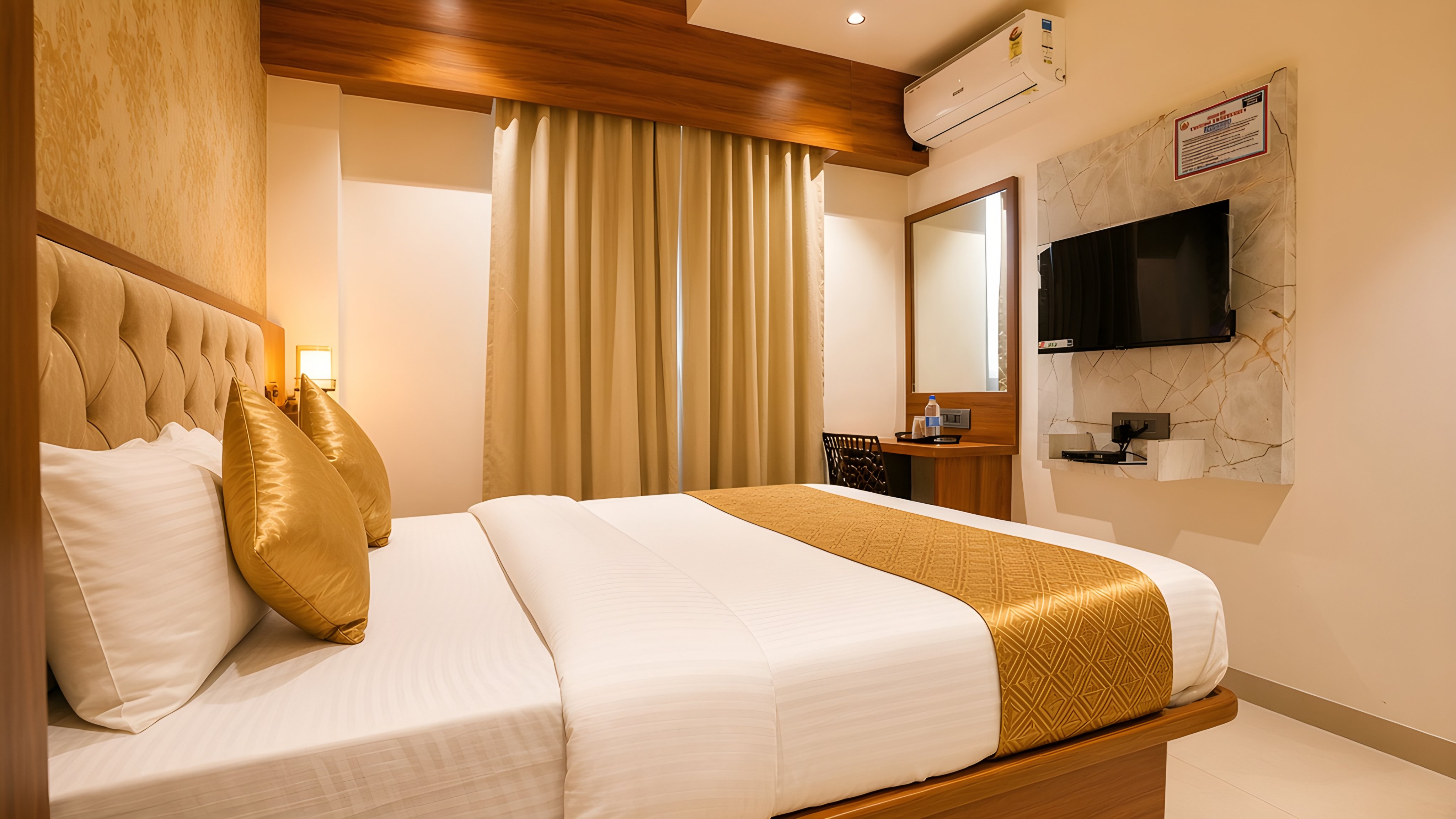 Deluxe room with curtains and a wall-mounted television